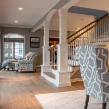 Living Room with Focus on Formal Staircase with White Custom Pillars