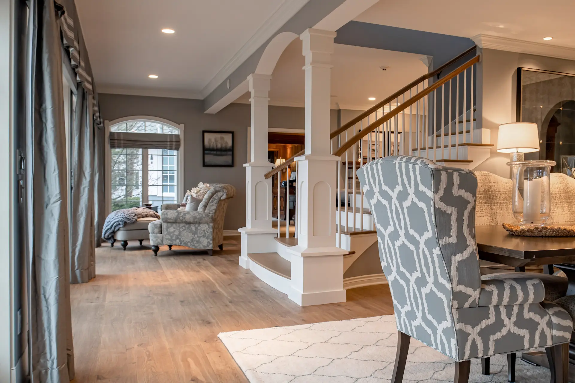 Living Room with Focus on Formal Staircase with White Custom Pillars