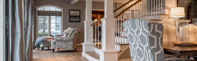 Gull Lake Custom Staircase Pillars | Pennings & Sons Living Room with Focus on Formal Staircase with White Custom Pillars