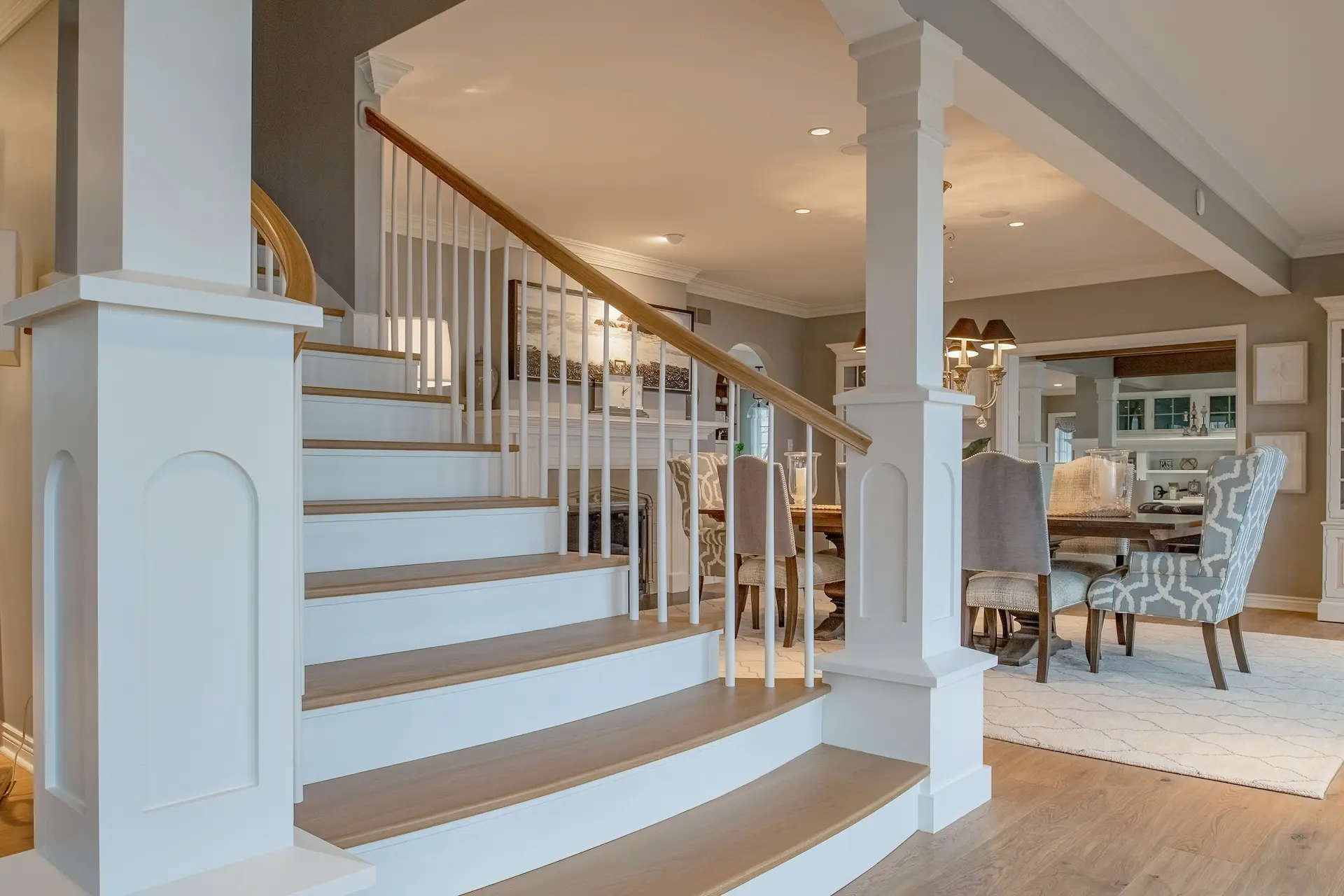 Formal Staircase with Floor to Ceiling White Pillars