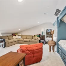 Spacious lakefront home loft with built-in bunk beds, sectional sofa, and family lounge area