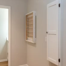 Custom wood built-in wall mounted in a closed position ironing board and drying rack