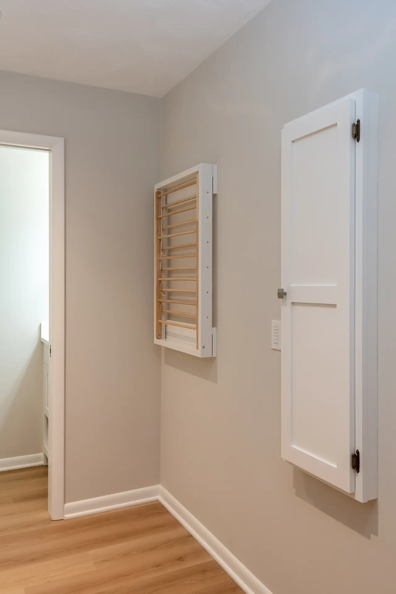 Custom wood built-in wall mounted in a closed position ironing board and drying rack