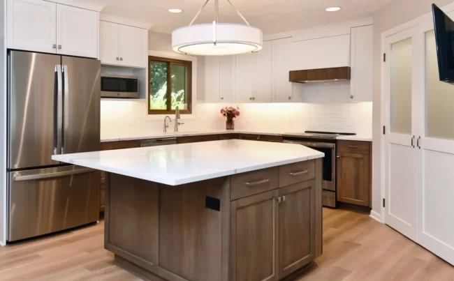 Custom Kitchen with Wood Island and White Cabinets | Pennings & Sons Custom kitchen with wood island, white upper cabinets, wood lower cabinets, quartz countertops, stainless steel appliances, and pendant light