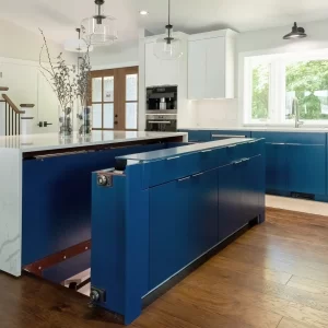 Custom blue kitchen island with concealed storage area and white quartz surround