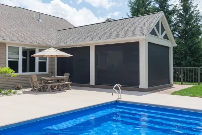 Covered Patio Expansion Full View | Pennings & Sons Side view of the covered patio expansion with pool with the screens closed
