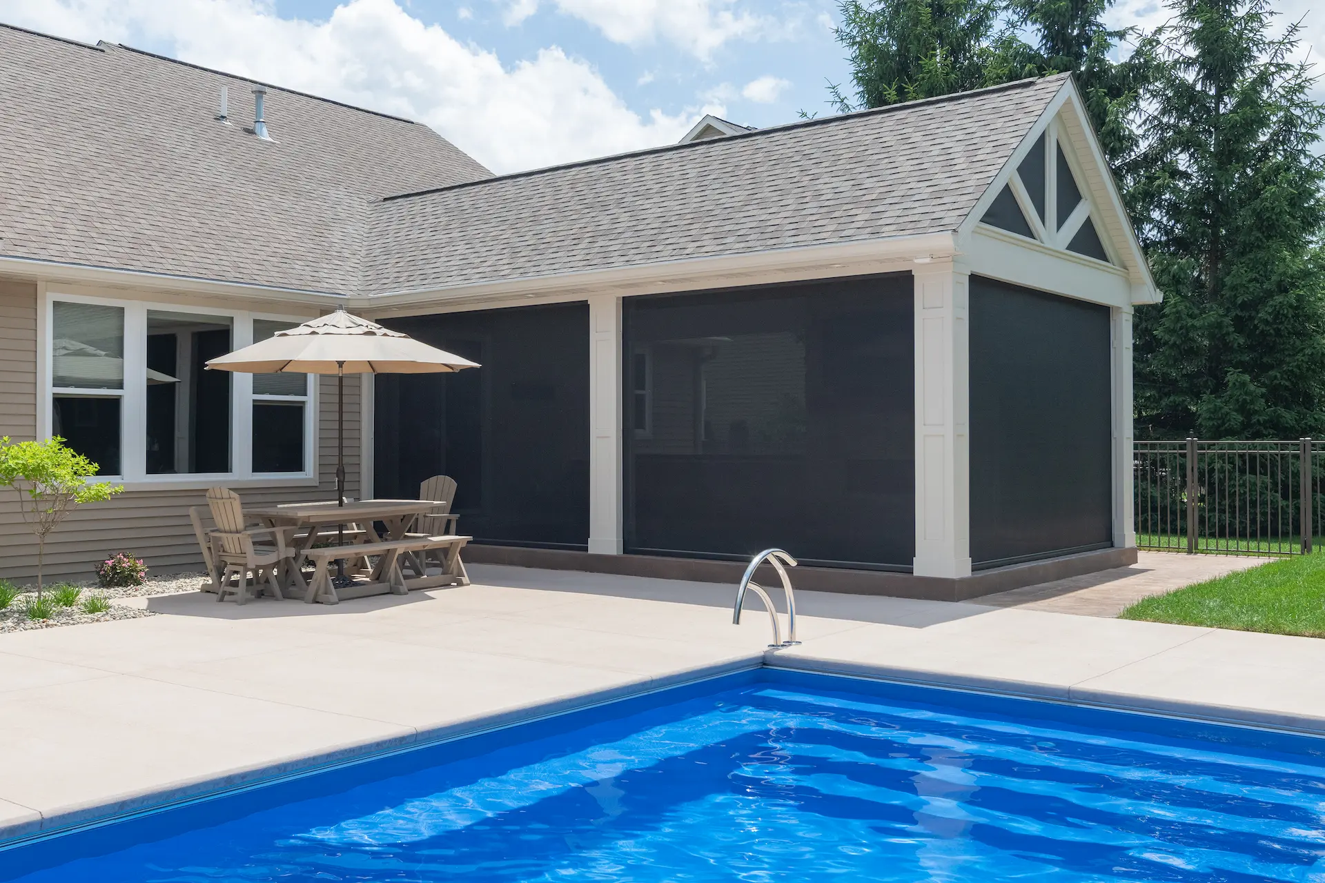 Side view of the covered patio expansion with pool with the screens closed