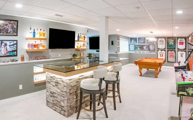 Sports Bar and Rec Room | Pennings & Sons Finished basement rec room with a custom bar, pool table, sports memorabilia, and arcade games