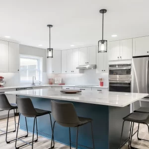 Large blue kitchen island with white countertop, bar seating, pendant lights, and updated cabinetry
